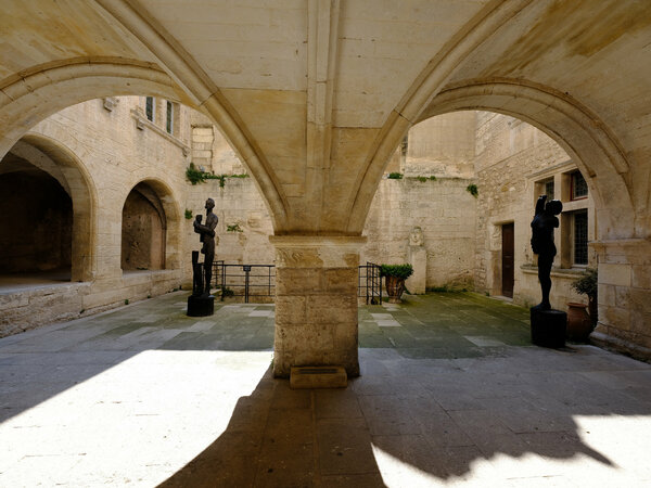 Modern statues in an ancient courtyard